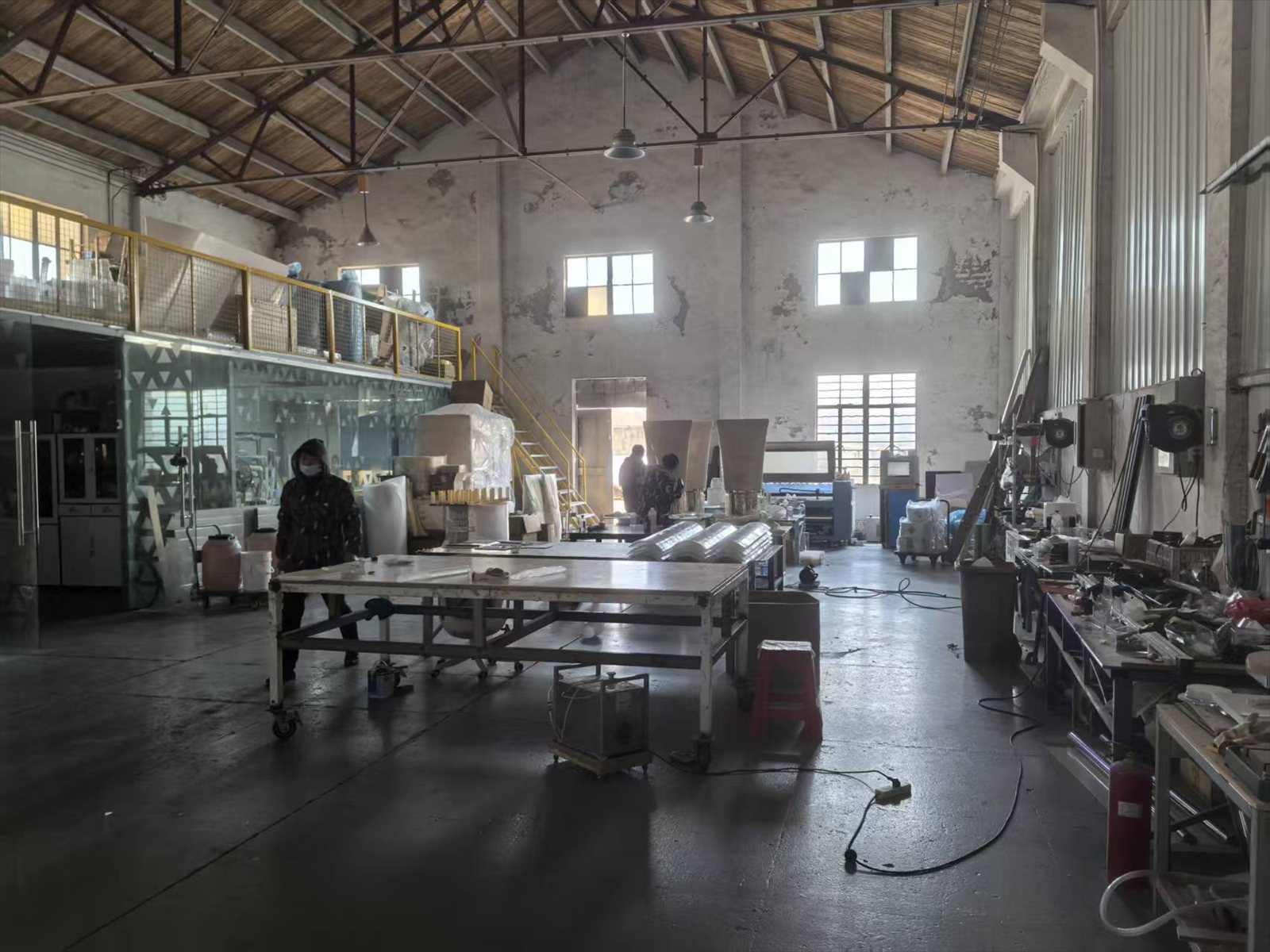 Wide view of the Key-Joint fabrication hall with workbenches, forming equipment and finishing stations
